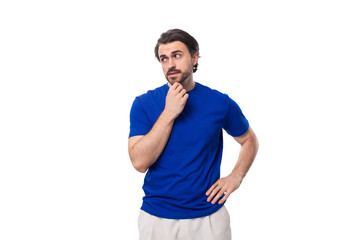 young smart handsome european man with black hair and beard dressed casually against the background with copy space