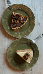 Pumpkin pie and carrot cake on vintage plate served with mulled wine on wooden rustic table, Christmas atmosphere