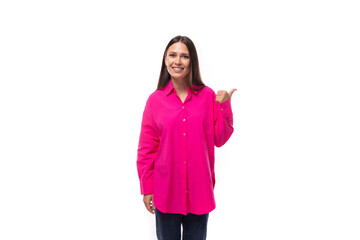 a smart caucasian woman with black straight hair is dressed in a crimson shirt with her index finger pointing at an empty space