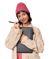 Young Hispanic female designer joyfully drawing on graphic tablet