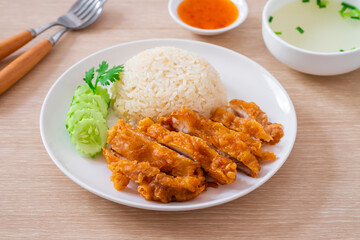 Hainanese chicken rice with fried chicken or oily rice with fried chicken and chili sauce