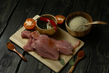 Raw chicken or turkey meat on a cutting board