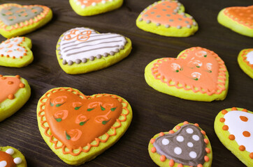 Heap of orange and yellow heart shaped with beautiful patterned royal icing cookies