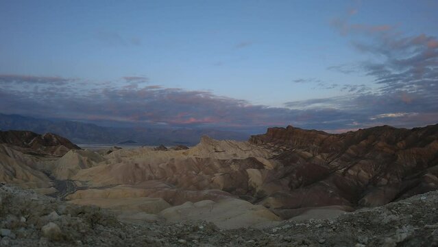 Time lapse of sunrise at Zabriskie Point, Death Valley National Park, California, USA. Cloud movement and golden light. No people.