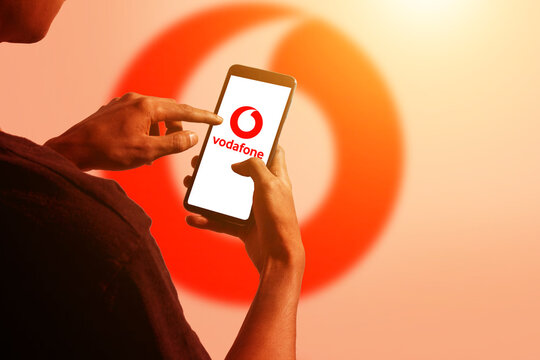 pringsewu, Lampung; November 26, 2023; A man's hand holds an Android cellphone with the logo of the British multinational telecommunications company "Vodafone" on the cellphone screen. optical flare