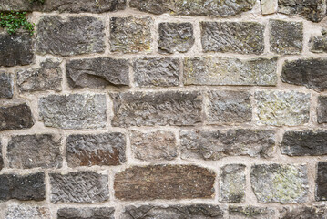 Architectural background texture of a medieval natural stone wall at the old castle Schaumburg, Germany