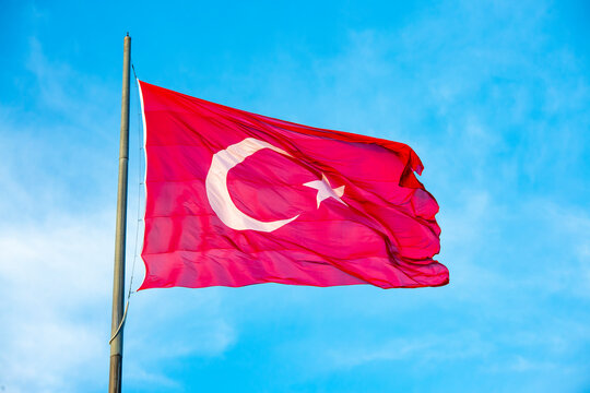 Turkey flag waving in blue cloud sky