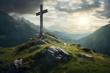 Wooden cross on the top of the mountain with clouds on the background