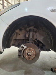 Disc brake of the vehicle for repair at garage, in process of new tire replacement, Suspension of...