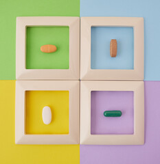 four frames with pills on a multi-colored background