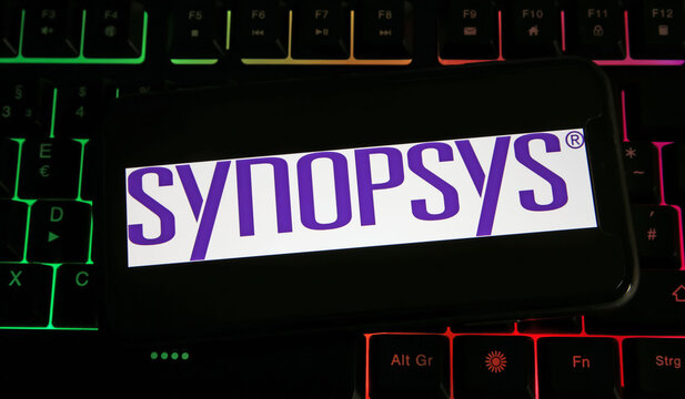 Viersen, Germany - July 9. 2023: Closeup of mobile phone on computer keyboard with logo lettering of Synopsys company