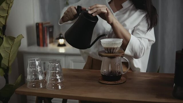 Woman makes pour over coffee at home. Pour-over coffee. 