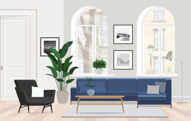 Blue sofa in a Scandinavian apartment with an armchair, coffee table and large windows.
