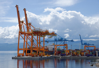 Fototapeta na wymiar Cargo container ship being loaded on a bright sunny day