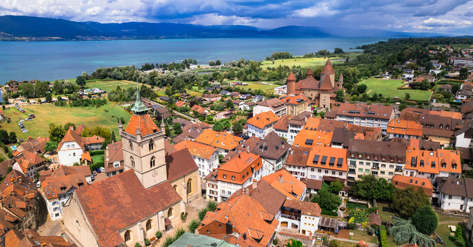 Aerial drone photo of medieval Estavayer-le-Lac castle and red roofs by Lake Neuchatel, Canton Fribourg, Switzerland Swiss riviera landscape. Lakeside fortification with copy space sky