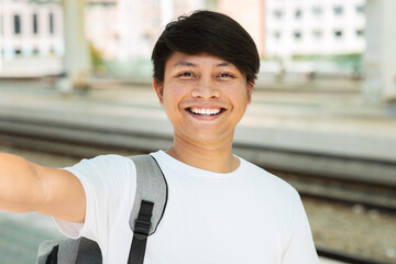 Closeup of asian guy tourist taking selfie