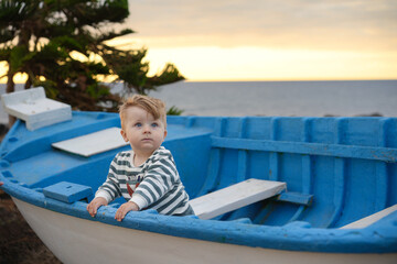 child on a boat at the beach
