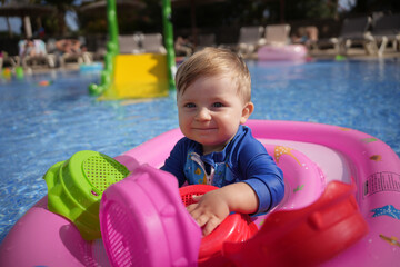 little child playing in the pool