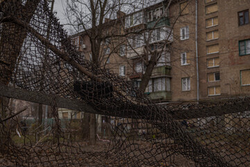 Kyiv, Ukraine - November 26, 2023: A fence mutilated by the blast wave when a downed drone fell...