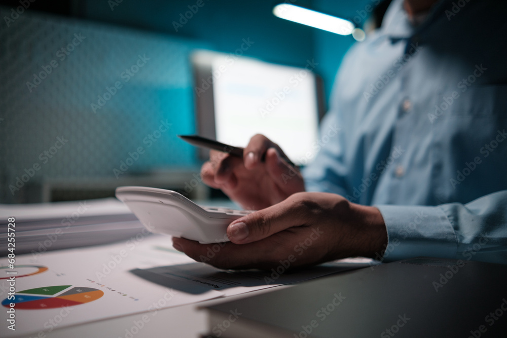 Poster accountant calculating numbers on calculator, auditor is working on accounting in the office,