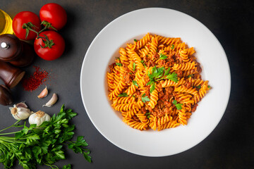 Fusilli pasta, spiral or spirali pasta with tomato, minced sauce - Italian food style