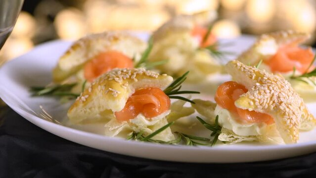 Festive appetizer of puff pastry in the shape of a star, stuffed with salmon and soft cheese. The perfect appetizer for your holiday table.