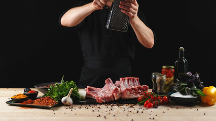 The chef cuts raw meat, BBQ ribs with a knife. Raw beef sliced on a wooden board. Delicious food...