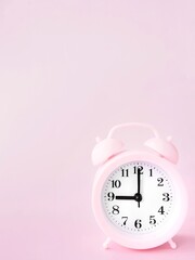 Pink background with alarm clock at 9 o clock and space to add text 