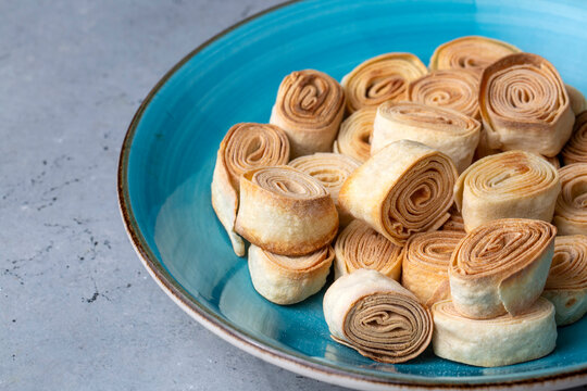 Turkish Food From Artvin called Silor - Rolled and Fried phyllo. Silor on blue plate.