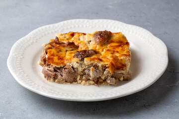 Tave kosi is a national Albanian dish of baked lamb and rice with yoghurt close-up in a pan on the table. horizontal top view from above. Turkish name; Elbasan tava - obrazy, fototapety, plakaty