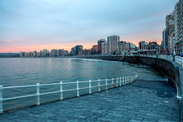 Gij&oacute;n at dusk promenade of the beach

