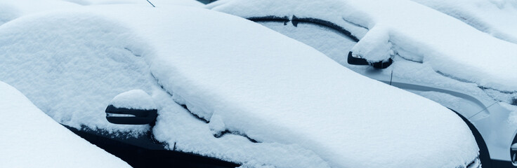 Parked cars covered with snow