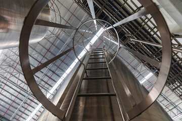 Tank farm with iron shadow staircase stainless stairway