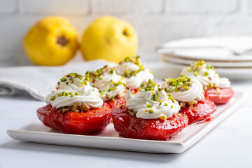 Traditional Turkish style quince dessert. The quince is cooked until soft, sherbet is poured on it, and served with cream and walnuts. It is one of the most popular Turkish desserts.(Ayva Tatlisi)