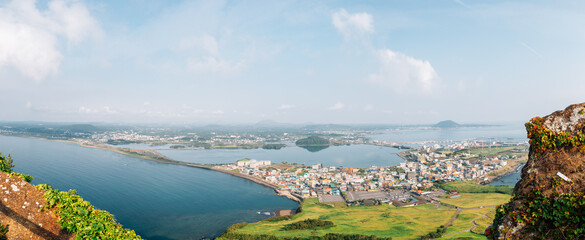 Panoramic view of sea and city from Seongsan Ilchulbong Tuff Cone in Jeju Island, Korea