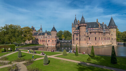 Fototapeta na wymiar Top view of the largest castle in the Netherlands, De Haar. A beautiful quadcopter flight over the castle, the park and the water moat around the castle. A beautiful park in English style.