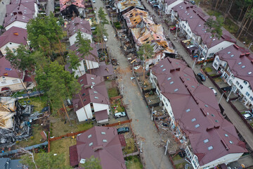 Hostomel, Kyev region Ukraine - 09.04.2022: Top view of the destroyed and burnt houses. Houses were destroyed by rockets or mines from Russian soldiers. Cities of Ukraine after the Russian occupation. - 684268142