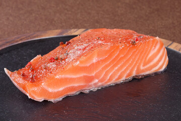 fresh salmon, cut and seasoned piece of fish