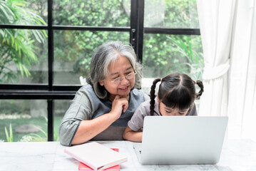 Asian family, Elderly grandmother daughters looking at tablet on marble table in the house, with...