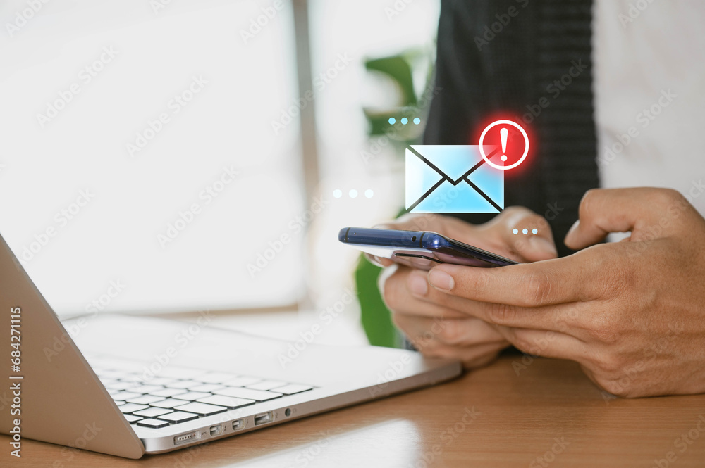 Poster a businessman at home using a smartphone to receive email warning alerts about spam, hackers, junk a