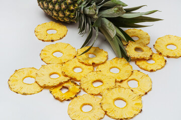 dried pineapple slices on a white background. dehydrator dried pineapple for cooking and drinking. pineapple chips on a light background