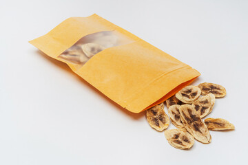 dried banana slices in a bag on a white background. banana dried in a dehydrator for preparing food and drinks. banana chips in a pack on a light background