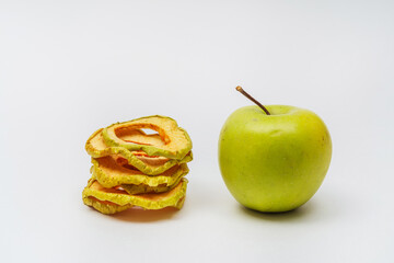 dried apple slices on a white background. apple dried in a dehydrator for preparing food and drinks. apple chips on a light background