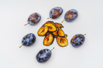dried plum slices on a white background. plums dried in a dehydrator for preparing food and drinks. plum chips on a light background