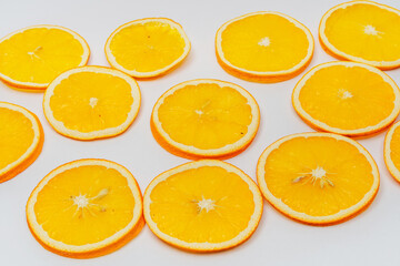 dried orange slices on a white background. orange dried in a dehydrator for preparing food and drinks. orange chips on a light background