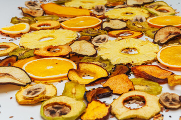 texture of dried fruits on a white background. assorted fruits from a dehydrator on a light background. dry fruit chips on a plain background