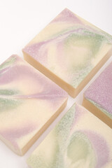 Four pieces of natural soap with an abstract pattern on white background. Soap closeup