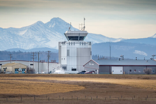 Springbank Alberta Canada, November 22 2023: Air Traffic Control Tower at a small airport West of Calgary overlooking the Canadian Rocky Mountains at background.
