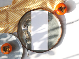 3.75 x 9 inch menu mockup with real natural sunlight.  Minimalist wedding menu on plate. chef's...