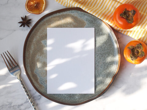3.75 x 9 inch menu mockup with real natural sunlight.  Minimalist wedding menu on plate. chef's table menu mockup